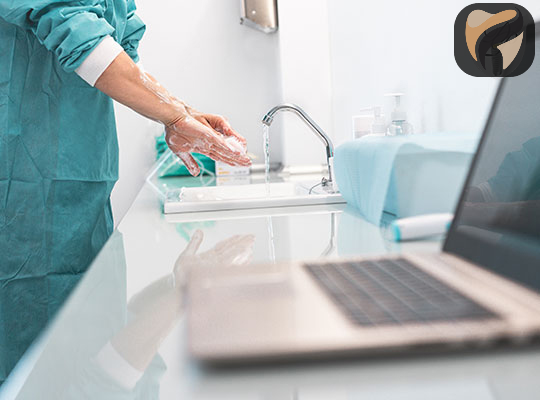 Dentist and dental team washing their hands before treating patients at YEC Dentistry in Midtown Toronto.