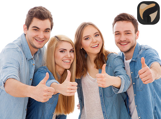 Two young couples giving a thumbs up after a positive dental experience at YEC Dentistry in Midtown Toronto.